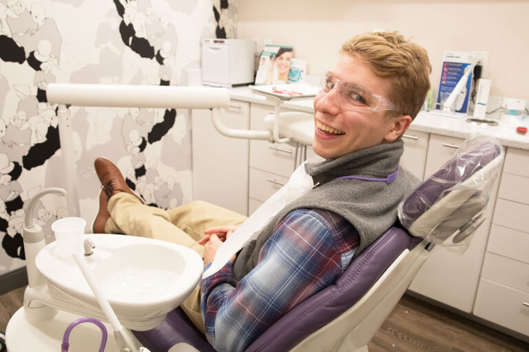 Happy Soul Dental patient sits in treatment chair, at ease and smiling.